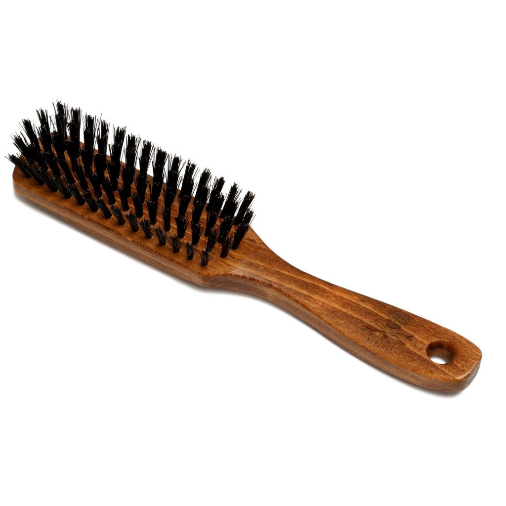 The Bluebeards Revenge Beard Brush with a sturdy beech wood handle and dense black vegan-friendly bristles, designed for professional-quality beard grooming.