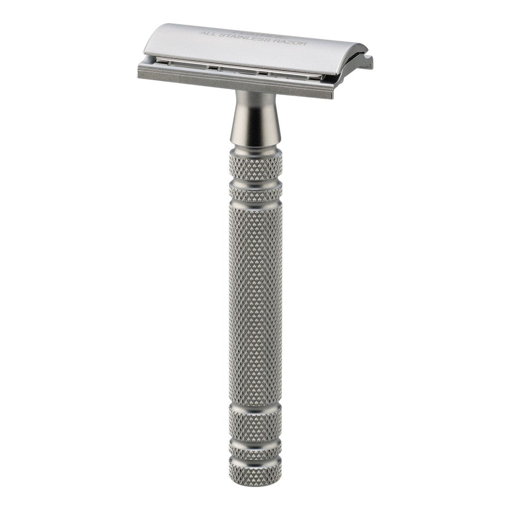 Feather All Stainless Safety Razor laying flat, highlighting the intricate knurling on the handle and sleek design.