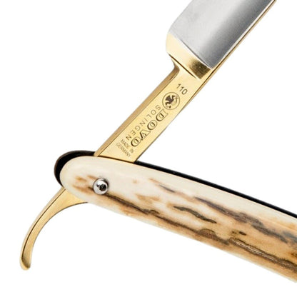 Detailed view of the Dovo Mammoth Ivory Razor's gold-etched tang and genuine ivory handle.