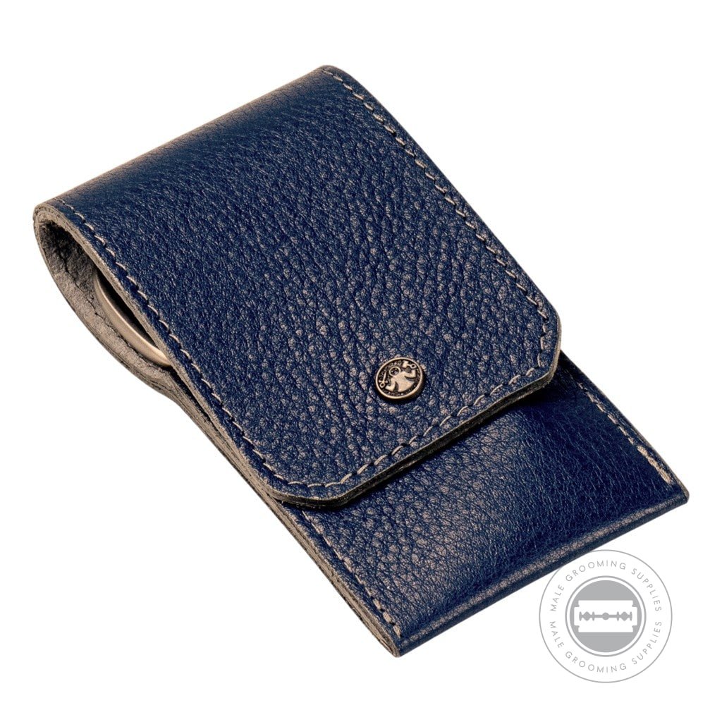 A closed Dovo navy blue leather manicure set, showcasing its premium textured cowhide leather finish with grey stitching and a secure snap closure.