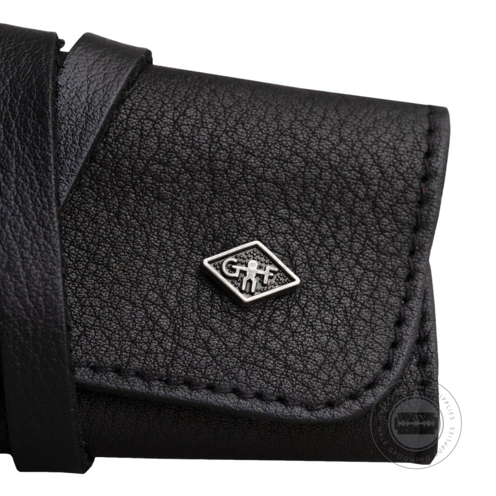 Close-up of G&F Timor® Black Leather Roll-Up Razor Case with logo detail and textured leather finish.