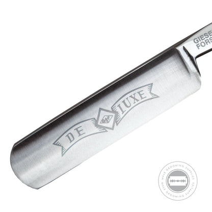 Close-up of the G&F Timor® Deluxe Razor 5/8 carbon steel blade with engraved 'De Luxe' logo.