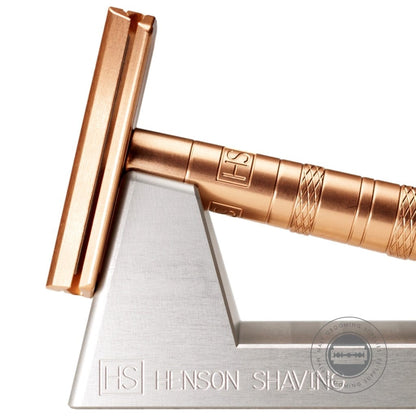 Close-up of the Henson AL13 Safety Razor V2.0 in Copper Edition on its stand, showcasing the elegant copper finish and precision-crafted head.