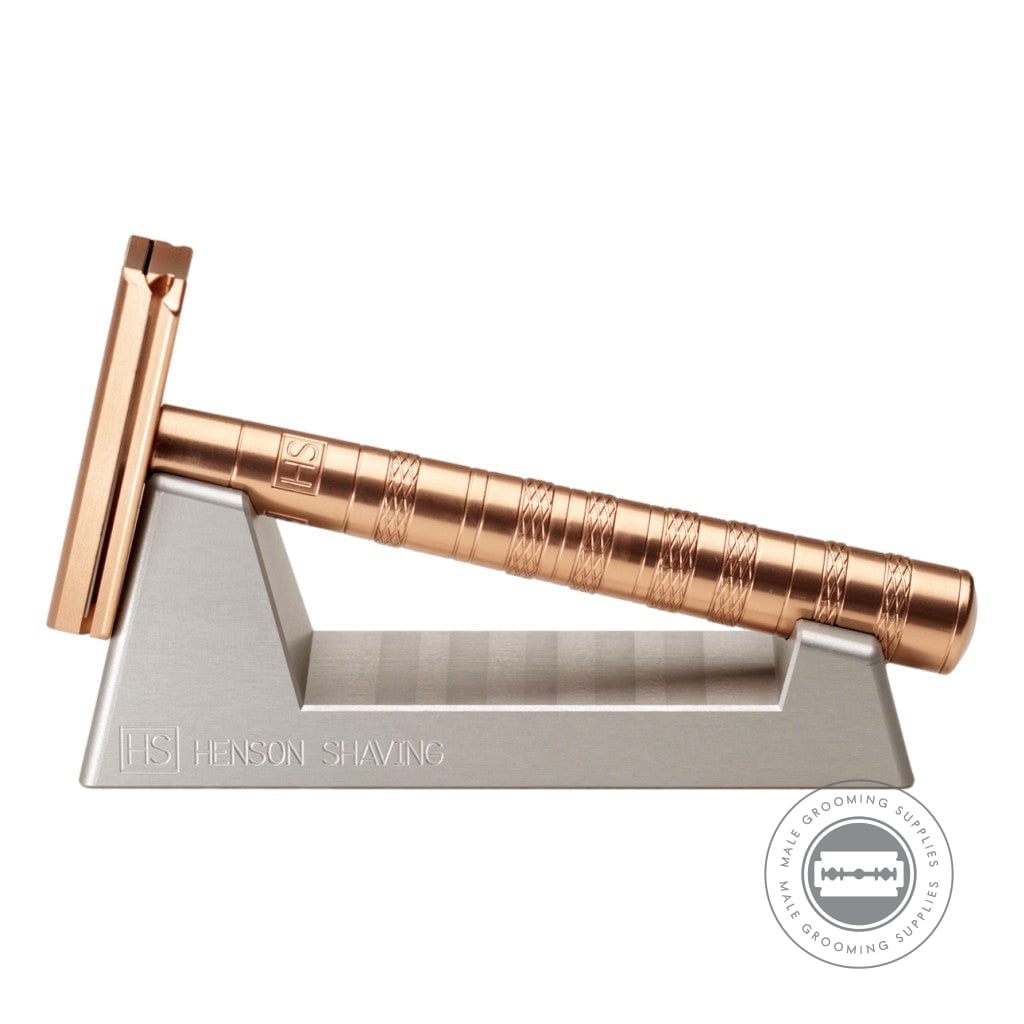 Henson AL13 Safety Razor V2.0 Copper Edition displayed on its stand, highlighting the anodized copper finish and ergonomic handle design.