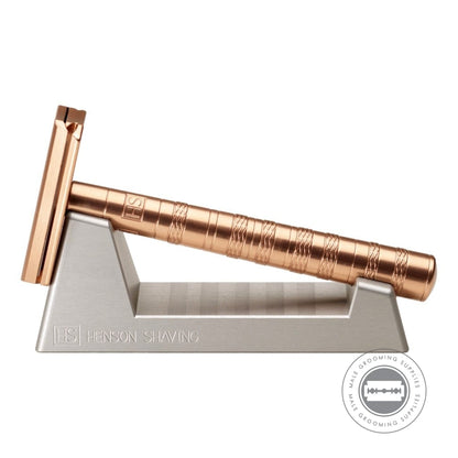 Henson AL13 Safety Razor V2.0 Copper Edition displayed on its stand, highlighting the anodized copper finish and ergonomic handle design.