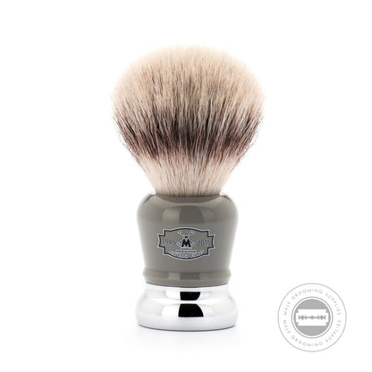 Close-up of the Muhle 70th Anniversary Silvertip Fibre® Shaving Brush with 70 years logo, featuring a grey high-grade resin handle and chrome-plated accents.