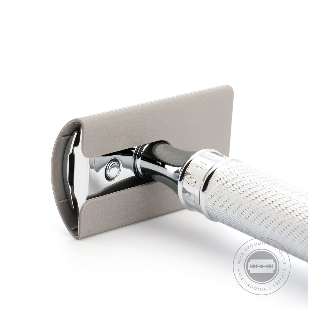 Muhle Blade Guard attached to a safety razor, showcasing its protective fit for safe storage and travel.