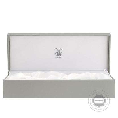 A grey MÜHLE-branded gift box lined with white satin, perfect for presenting shaving accessories.