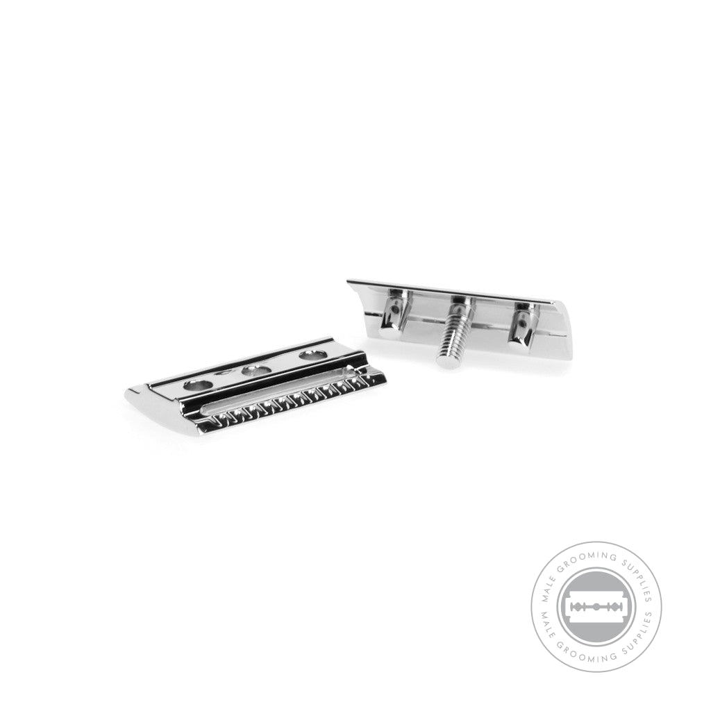 Close-up view of disassembled Muhle R108 Safety Razor head, showing blade alignment and chrome-plated components.