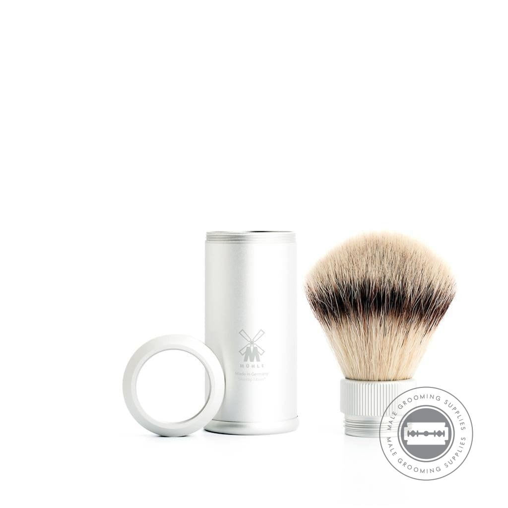 Mühle Travel Shaving Brush with detachable Silvertip Fibre brush head, silver anodised aluminium handle, and parts displayed separately.