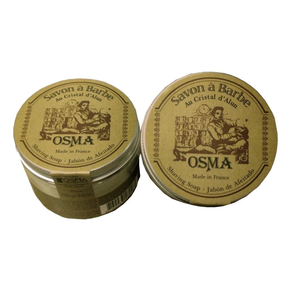 Osma Shaving Soap 100g in aluminium twist-cap containers with vintage-style brown labels, featuring natural ingredients like kaolin and shea butter, made in France.