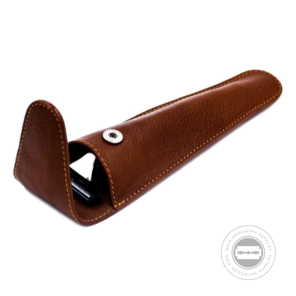 Open Parker leather razor pouch in saddle brown with visible snap closure.